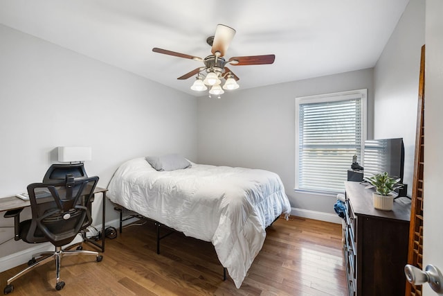 bedroom with hardwood / wood-style flooring and ceiling fan