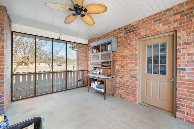 sunroom / solarium featuring ceiling fan