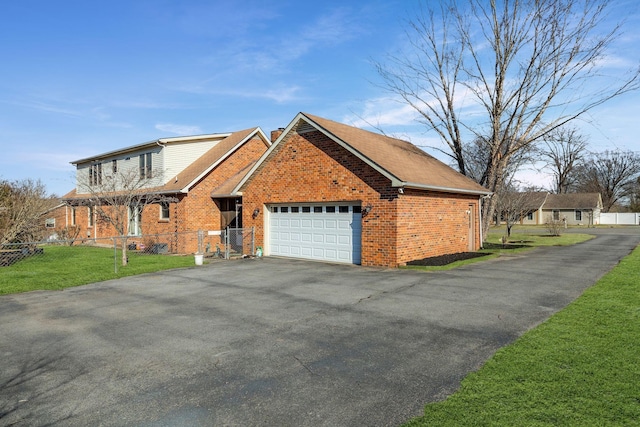 view of front facade with a garage and a front lawn