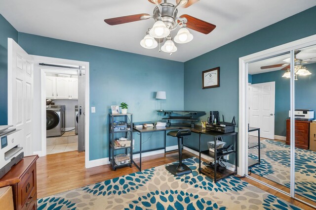 office with ceiling fan, independent washer and dryer, and light hardwood / wood-style flooring