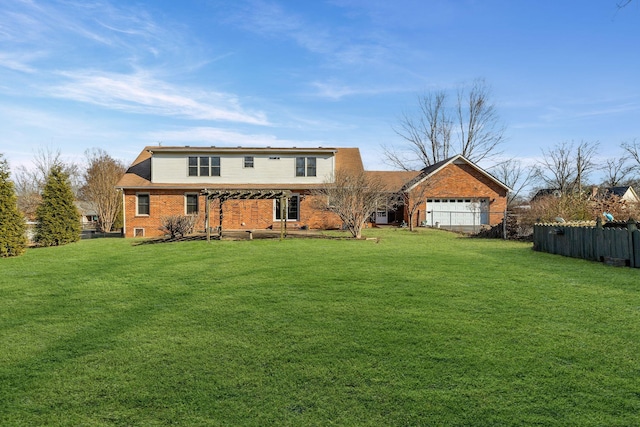 rear view of property featuring a yard and a garage