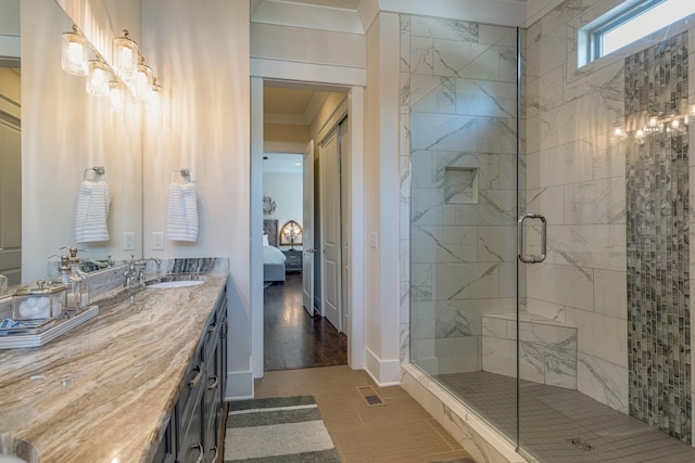 bathroom featuring an enclosed shower and vanity