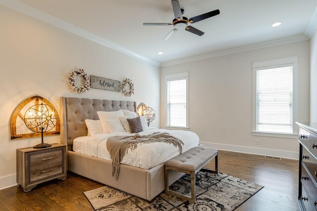 bedroom with multiple windows, crown molding, and dark wood-type flooring