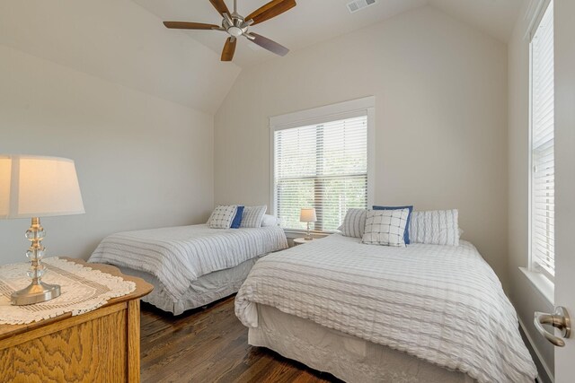 bedroom with ceiling fan, lofted ceiling, and dark hardwood / wood-style flooring