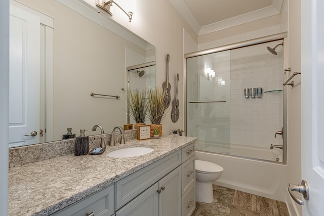 full bathroom with bath / shower combo with glass door, vanity, and toilet