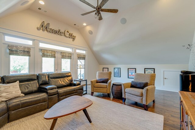 living room with ceiling fan, lofted ceiling, and dark hardwood / wood-style flooring