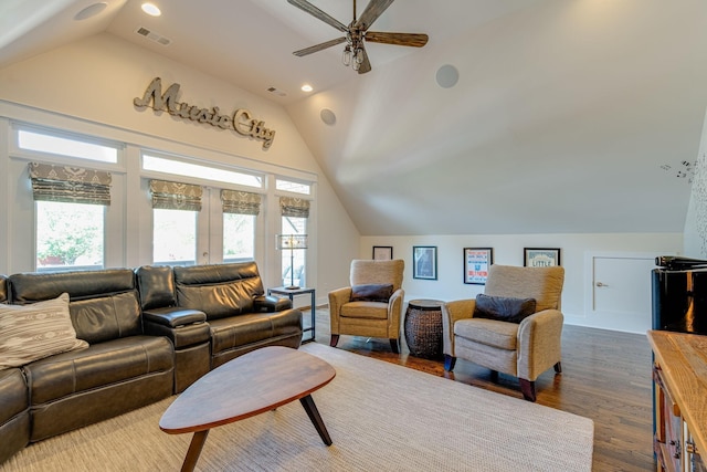 living room with ceiling fan, lofted ceiling, and dark hardwood / wood-style flooring