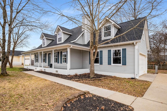 cape cod home with a garage and a porch