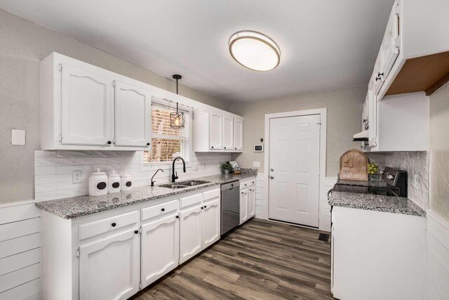 kitchen with pendant lighting, sink, stainless steel dishwasher, and white cabinets