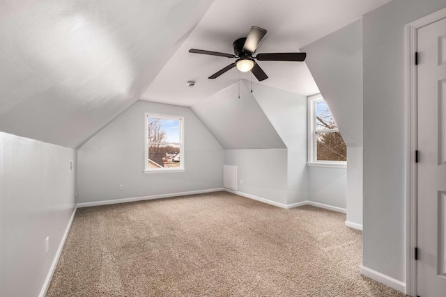 bonus room featuring lofted ceiling, light carpet, and ceiling fan