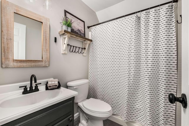 bathroom with vanity, walk in shower, and toilet