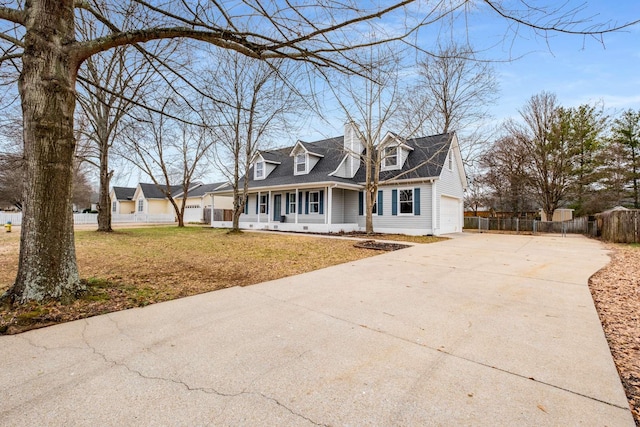 new england style home featuring a porch, a garage, and a front lawn