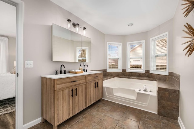 bathroom featuring a washtub and vanity