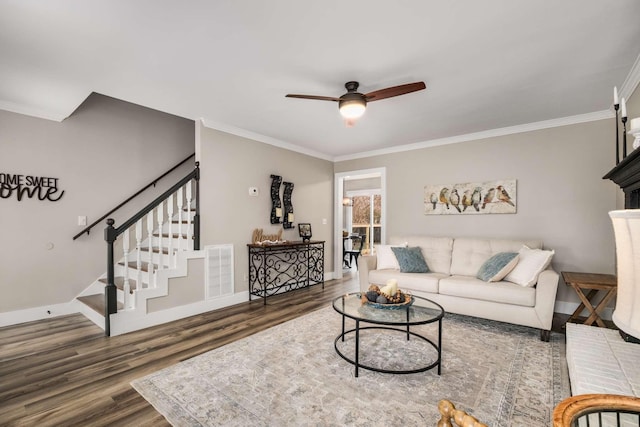 living room featuring ceiling fan, ornamental molding, and dark hardwood / wood-style flooring