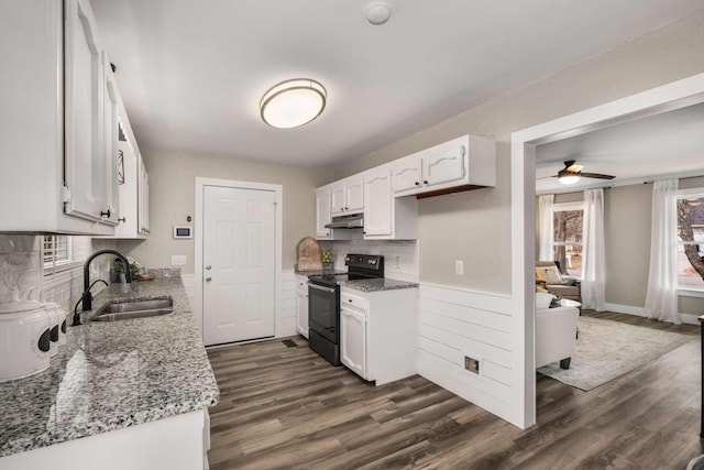 kitchen with white cabinetry, sink, black electric range, and stone countertops