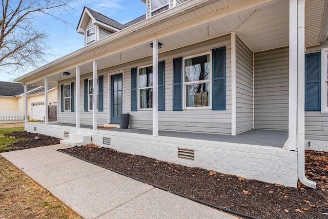 view of side of property featuring covered porch