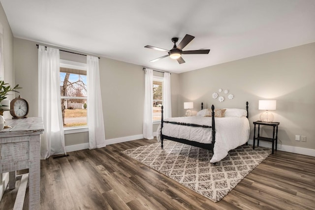 bedroom with dark wood-type flooring, ceiling fan, and multiple windows