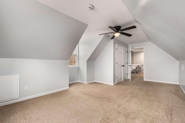 bonus room with light carpet, lofted ceiling, and ceiling fan