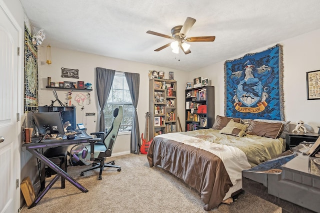 carpeted bedroom with a textured ceiling and ceiling fan