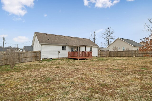 back of house featuring a wooden deck and a lawn