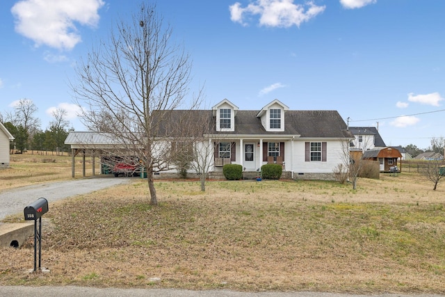 new england style home featuring a carport, covered porch, and a front lawn