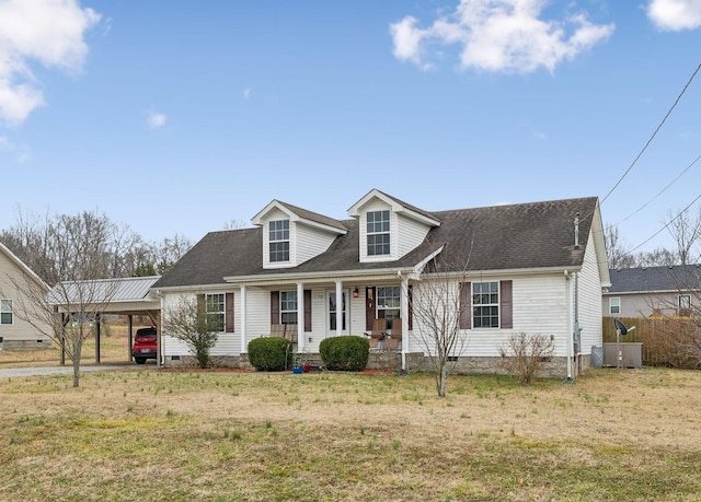 cape cod home with central AC unit, a front yard, a carport, and a porch