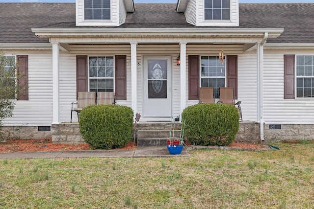 doorway to property with a yard and a porch