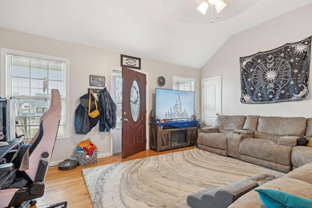 living room featuring vaulted ceiling and hardwood / wood-style floors