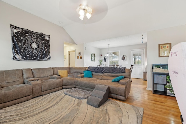 living room featuring ceiling fan, vaulted ceiling, and light hardwood / wood-style flooring