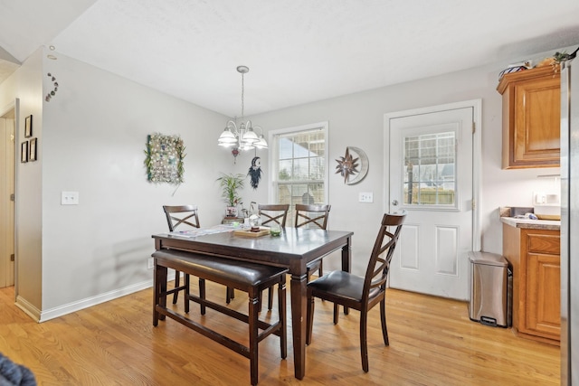 dining room featuring an inviting chandelier and light hardwood / wood-style floors