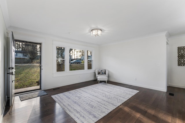 living area featuring ornamental molding and dark hardwood / wood-style flooring