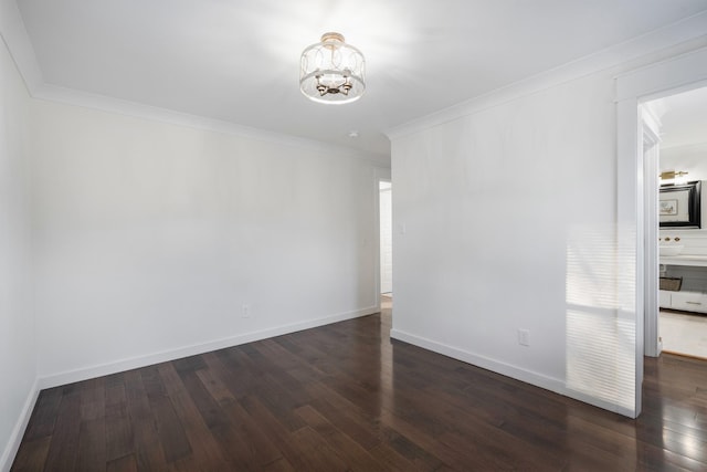 unfurnished room with crown molding, dark hardwood / wood-style flooring, and a chandelier