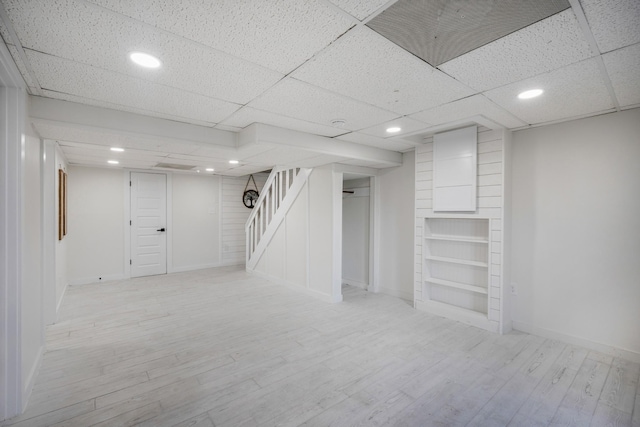 basement with light hardwood / wood-style flooring