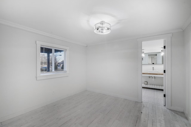 empty room with ornamental molding and light hardwood / wood-style flooring