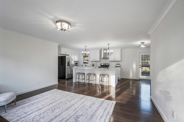 living room with an inviting chandelier, ornamental molding, dark hardwood / wood-style floors, and a wealth of natural light