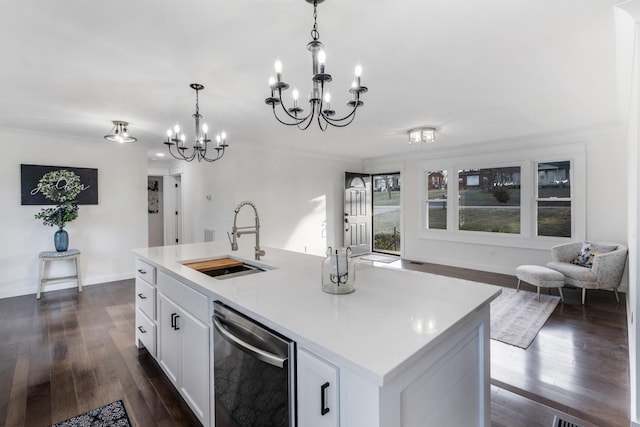 kitchen featuring sink, hanging light fixtures, stainless steel dishwasher, an island with sink, and white cabinets