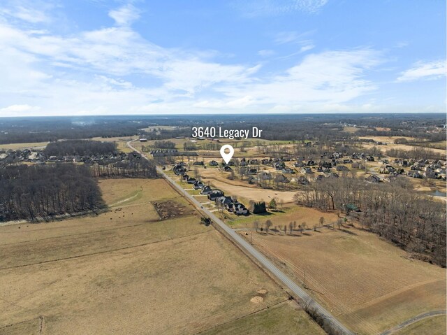 birds eye view of property with a rural view