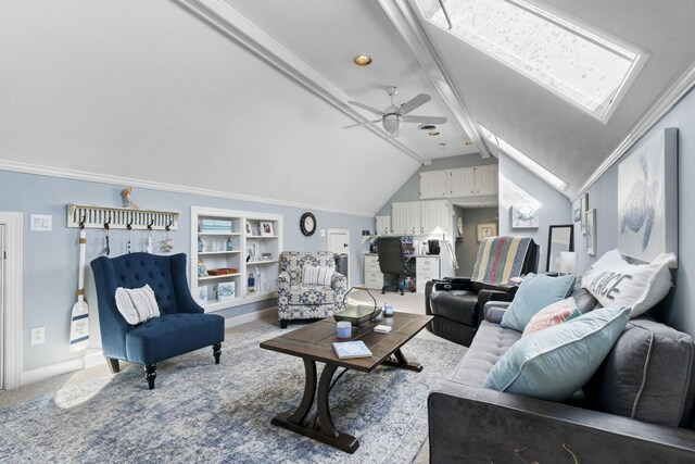 carpeted living room featuring vaulted ceiling with skylight and ceiling fan