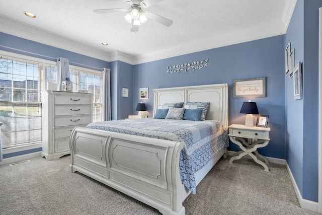 carpeted bedroom featuring ornamental molding and ceiling fan