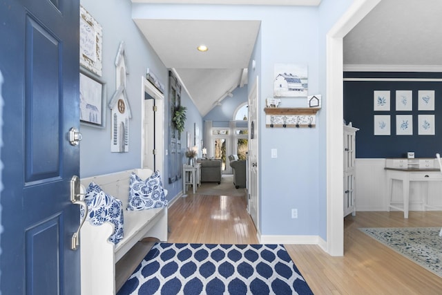 corridor with vaulted ceiling and light hardwood / wood-style floors