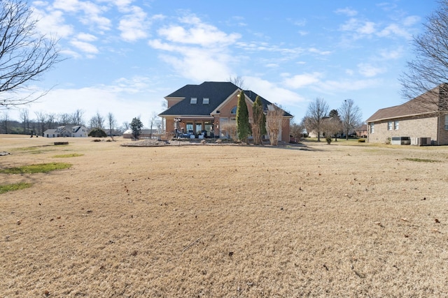 back of property featuring a yard