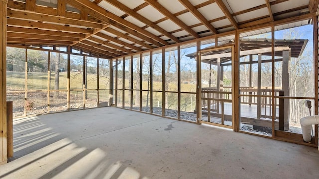 unfurnished sunroom featuring vaulted ceiling