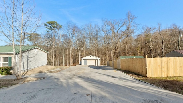 view of yard featuring an outbuilding and a garage