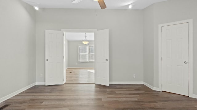 spare room featuring dark hardwood / wood-style floors and ceiling fan