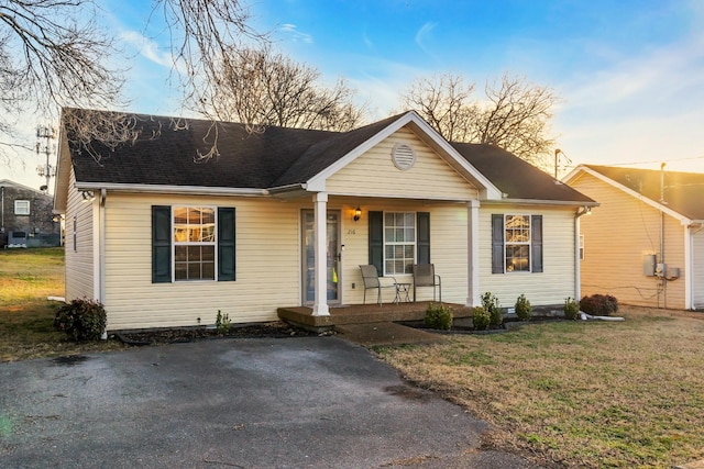 view of front facade with a yard and a porch