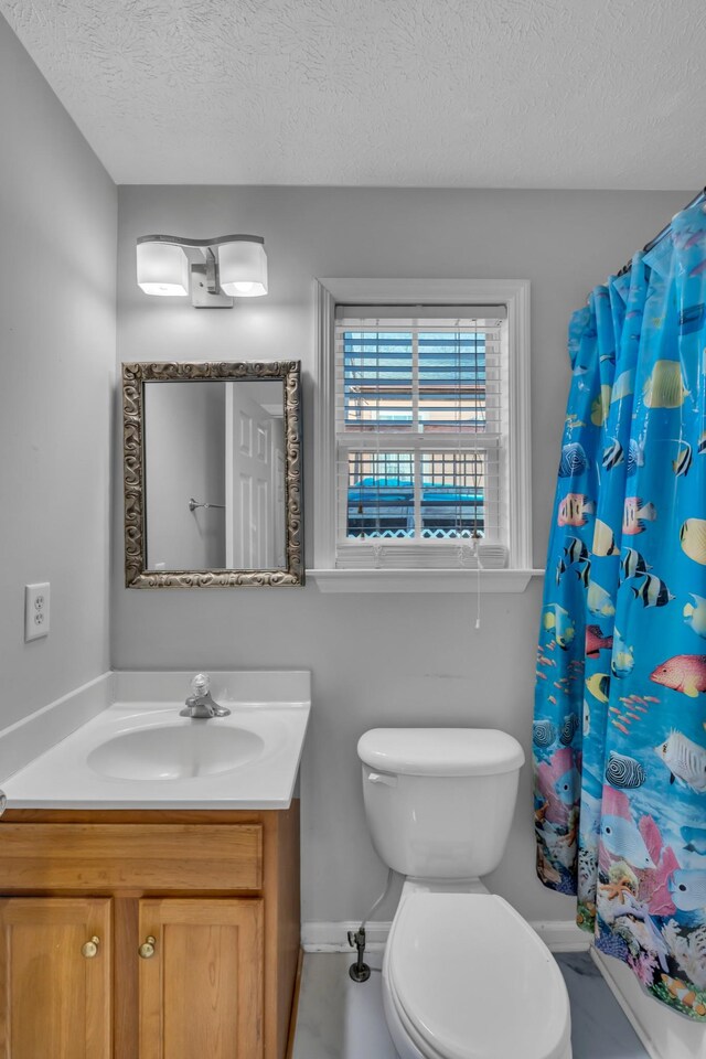 bathroom featuring vanity, a shower with shower curtain, a textured ceiling, and toilet