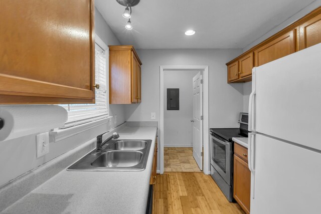 kitchen with sink, white refrigerator, electric range, electric panel, and light wood-type flooring