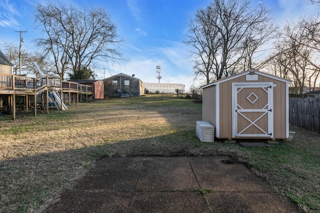 view of yard with a storage shed and a deck