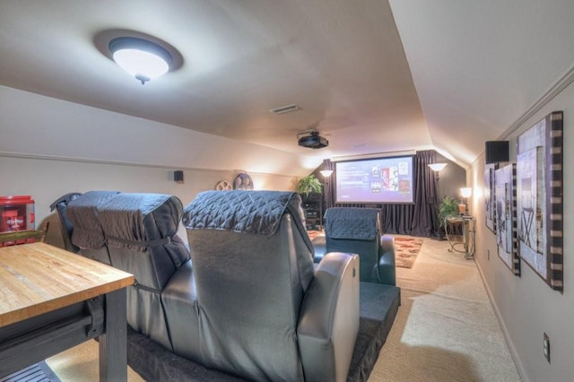 cinema room with vaulted ceiling and light carpet