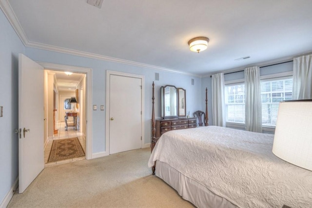 carpeted bedroom with ornamental molding